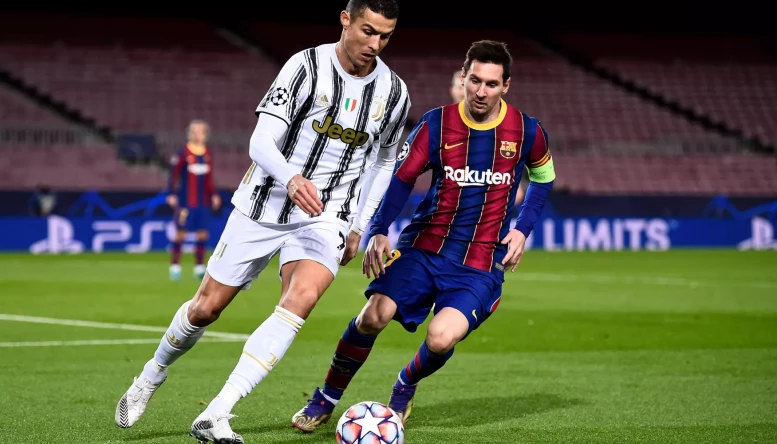 Cristiano Ronaldo  challenged by Lionel Messi