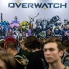 Young people stand in a line to play the Overwatch video game at the Comic Con