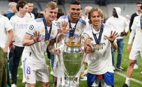 Real Madrid's Toni Kroos, Carlos Casemiro and Luka Modric with the trophy after the UEFA Champions League Final at the Stade de France, Paris
