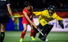China's Zhang Xiaoxue and Belgium's goalkeeper Aisling D'hooghe pictured in action during a hockey match between the Belgian Red Panthers and China in the group stage (game 10 out of 16) of t