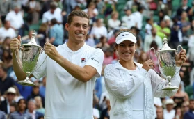 Wimbledon Tennis tournament; Neal Skupski (GBR) and Desirae Krawczyk (USA) lift the Mixed Doubles Trophy after defeating Samantha Stosur (AUS) and Matthew Ebden (AUS) in two sets
