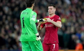 Liverpool's James Milner give the captains armband to goalkeeper Alisson during the UEFA Champions League quarter final