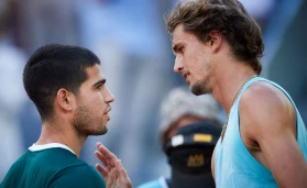 Alexander Zverev (R) of Germany talks to Carlos Alcaraz of Spain after their men's singles final at the Madrid Open in Madrid