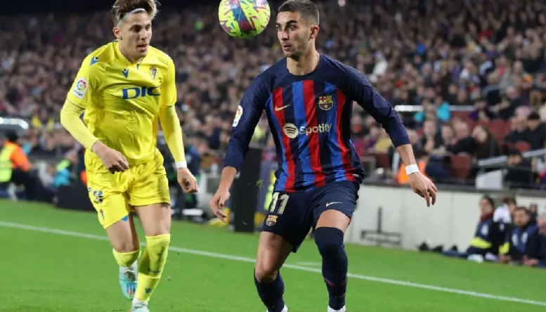 Ferran Torres of Barcelona and Ivan Alejo of Cadiz battle for the ball