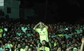 Kerala Blasters Fans watch on a big screen at the football ground at Nainambalappu in Kerala