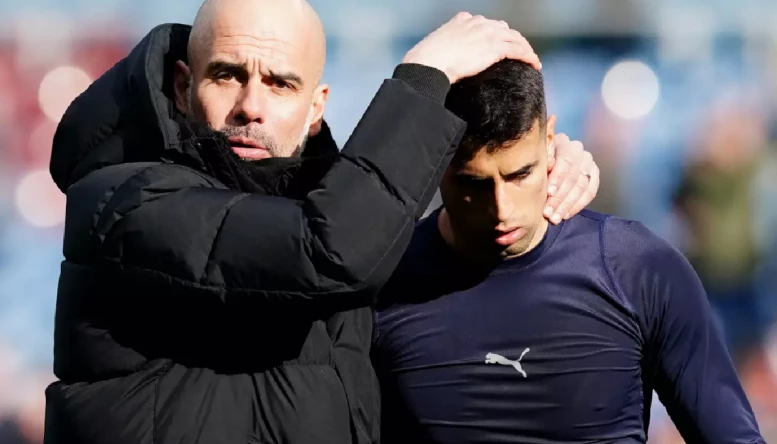 Pep Guardiola and Joao Cancelo.