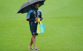 Rohit Sharma takes cover from the rain